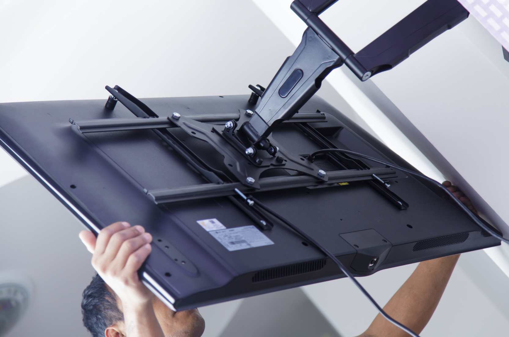 Television being secured to an articulating wall mount